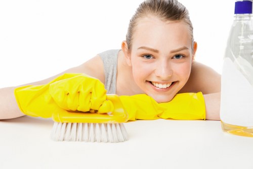 Cleaner wearing PPE while inspecting a carpet cleaning area